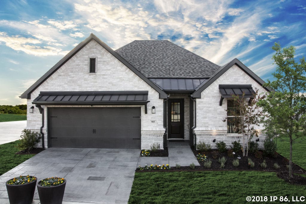 A striking exterior with contrasting white and black features and a front garden.